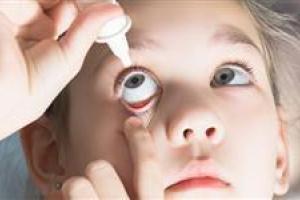 young-girl-putting-in-eye-drop-big-spotlight