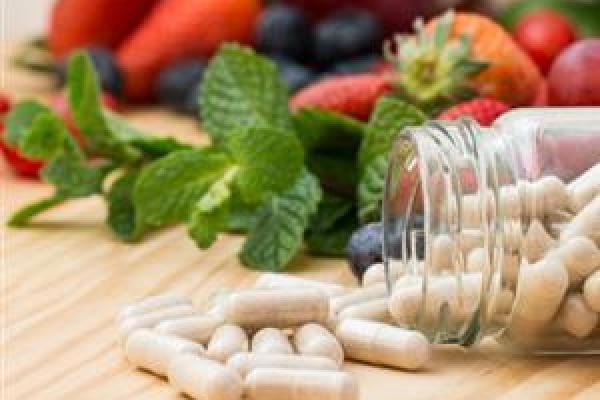 supplement-pills-and-fruit-on-wooden-table