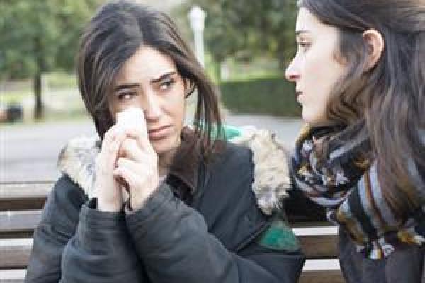 woman-crying-on-park-bench-with-friend
